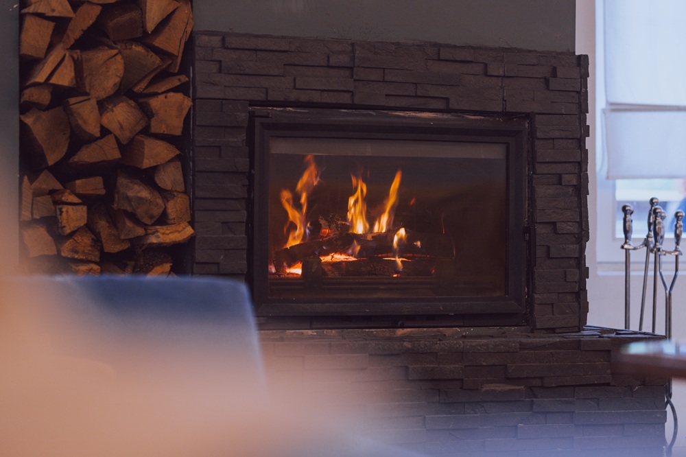 Close-up of wood burning in a stone fireplace inside a residential home